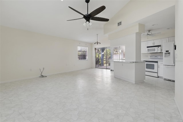 23116 Amethyst Ave, Port Charlotte, FL 33952 - unfurnished living room featuring high vaulted ceiling, ceiling fan, baseboards, and visible vents