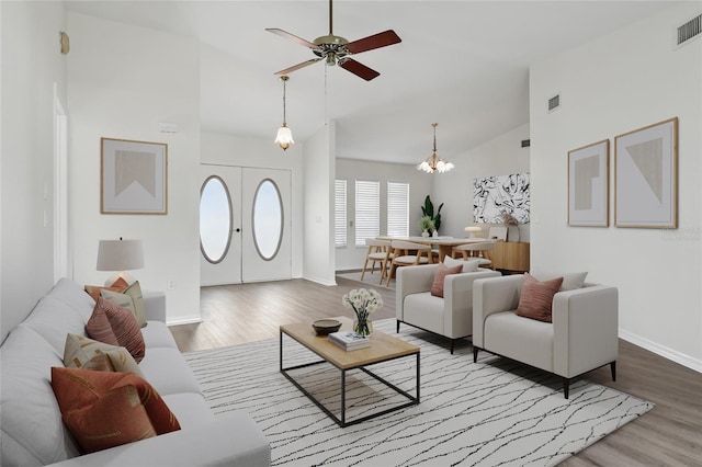 23116 Amethyst Ave, Port Charlotte, FL 33952 - living area featuring baseboards, ceiling fan with notable chandelier, high vaulted ceiling, and wood finished floors