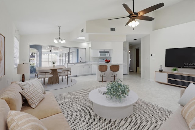 23116 Amethyst Ave, Port Charlotte, FL 33952 - living area with visible vents, light floors, ceiling fan with notable chandelier, and high vaulted ceiling