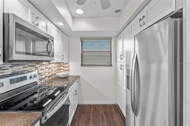 1233 Dockside Pl Unit 207, Sarasota, FL 34242 - kitchen featuring stainless steel appliances, baseboards, decorative backsplash, white cabinets, and recessed lighting