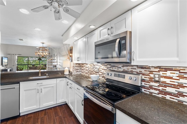 1233 Dockside Pl Unit 207, Sarasota, FL 34242 - kitchen featuring appliances with stainless steel finishes, white cabinets, ceiling fan, decorative backsplash, and recessed lighting