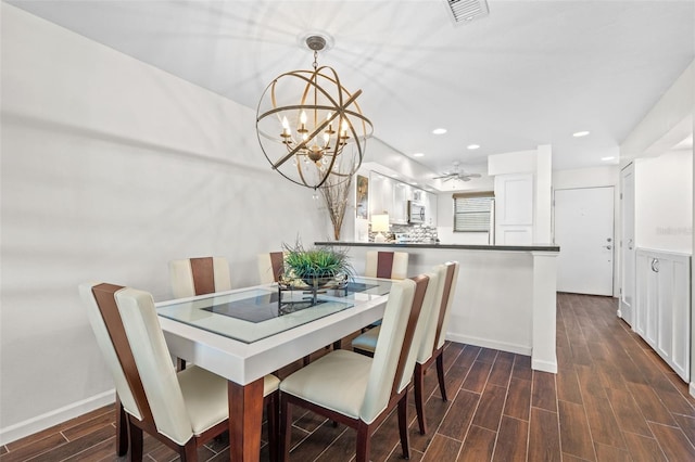 1233 Dockside Pl Unit 207, Sarasota, FL 34242 - dining room featuring dark wood-type flooring, a chandelier, recessed lighting, baseboards, and ceiling fan