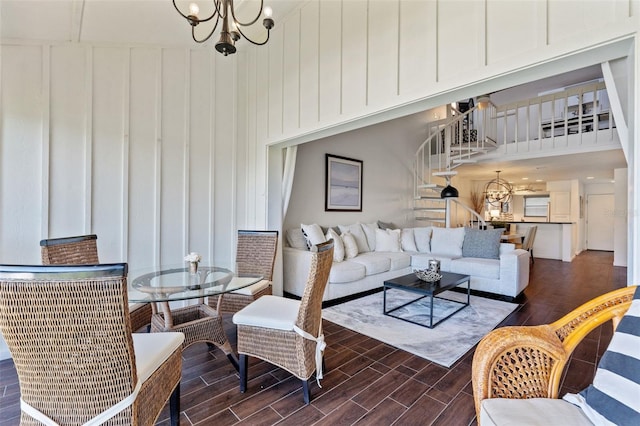 1233 Dockside Pl Unit 207, Sarasota, FL 34242 - living room with a towering ceiling, a chandelier, wood finish floors, stairway, and a decorative wall