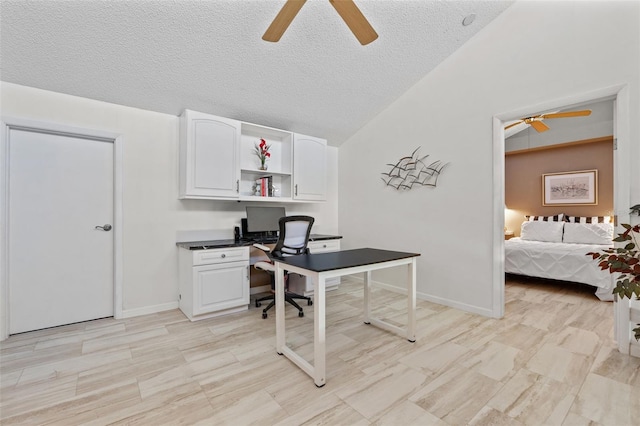 1233 Dockside Pl Unit 207, Sarasota, FL 34242 - office with ceiling fan, a textured ceiling, vaulted ceiling, and baseboards