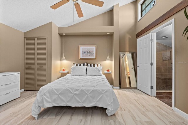 1233 Dockside Pl Unit 207, Sarasota, FL 34242 - bedroom featuring lofted ceiling, a closet, baseboards, a ceiling fan, and a textured ceiling