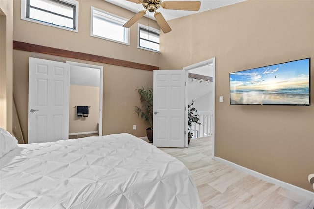 1233 Dockside Pl Unit 207, Sarasota, FL 34242 - bedroom with a towering ceiling, baseboards, and ceiling fan