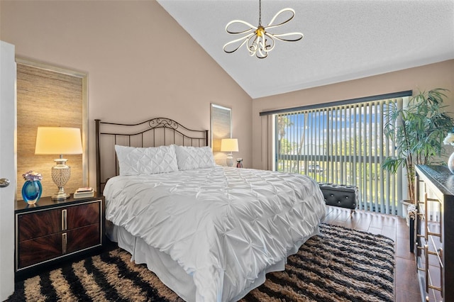 1233 Dockside Pl Unit 207, Sarasota, FL 34242 - bedroom with a chandelier, high vaulted ceiling, access to exterior, and a textured ceiling