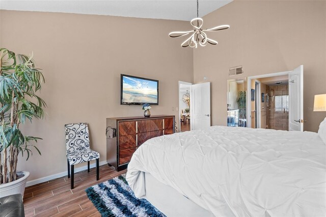 1233 Dockside Pl Unit 207, Sarasota, FL 34242 - bedroom with a chandelier, high vaulted ceiling, baseboards, and wood finished floors