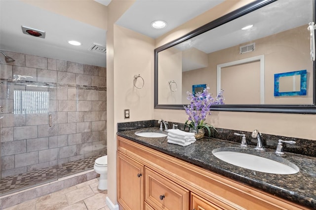 1233 Dockside Pl Unit 207, Sarasota, FL 34242 - bathroom featuring toilet, double vanity, a stall shower, recessed lighting, and tile patterned floors