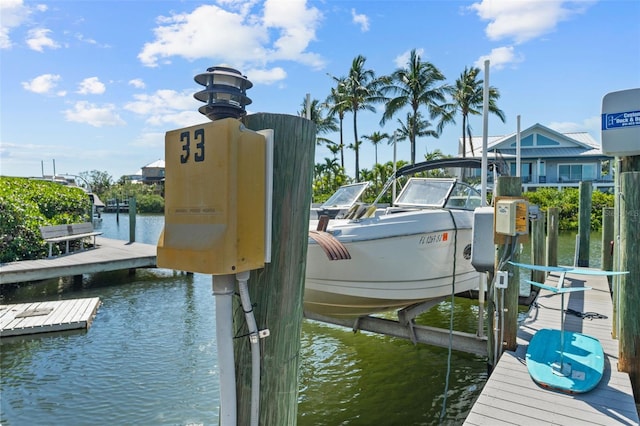 1233 Dockside Pl Unit 207, Sarasota, FL 34242 - dock featuring boat lift and a water view