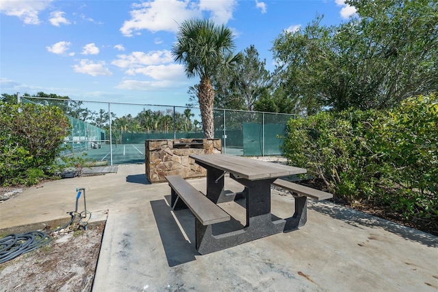 1233 Dockside Pl Unit 207, Sarasota, FL 34242 - view of patio with a tennis court and outdoor dining area