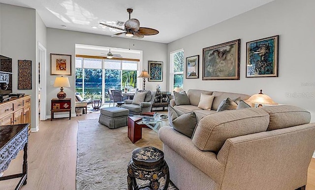 4136 Cascade Falls Dr, Sarasota, FL 34243 - living area with a ceiling fan, light wood-style flooring, and baseboards