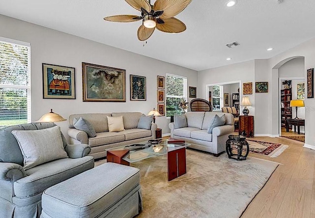 4136 Cascade Falls Dr, Sarasota, FL 34243 - living room featuring light wood-style floors, plenty of natural light, ceiling fan, recessed lighting, and arched walkways