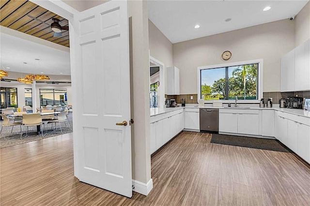 4136 Cascade Falls Dr, Sarasota, FL 34243 - kitchen featuring dishwasher, modern cabinets, wood finished floors, white cabinetry, and recessed lighting