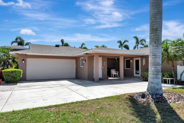 5209 26th Ave W, Bradenton, FL 34209 - ranch-style home featuring a garage, stucco siding, concrete driveway, and roof with shingles
