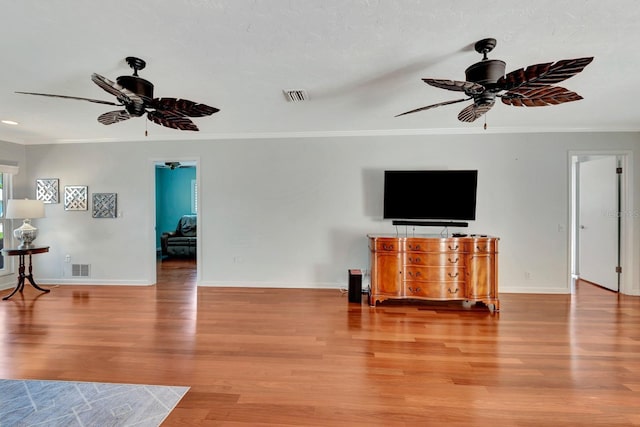 5209 26th Ave W, Bradenton, FL 34209 - unfurnished living room with ceiling fan, ornamental molding, light wood-style floors, and baseboards