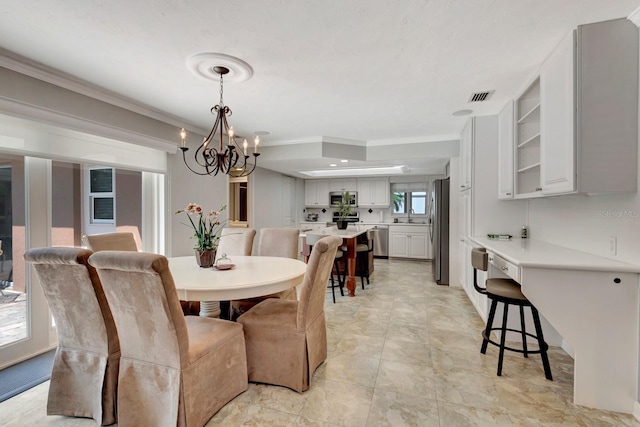 5209 26th Ave W, Bradenton, FL 34209 - dining area featuring a chandelier and crown molding