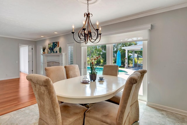 5209 26th Ave W, Bradenton, FL 34209 - dining area with crown molding, a chandelier, baseboards, and a fireplace