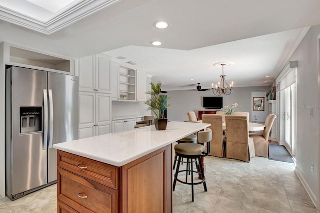 5209 26th Ave W, Bradenton, FL 34209 - kitchen with stainless steel fridge, crown molding, open floor plan, white cabinetry, and open shelves