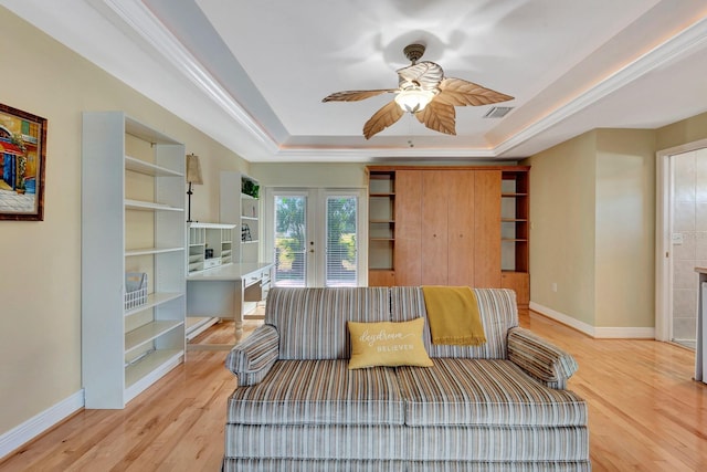 5209 26th Ave W, Bradenton, FL 34209 - living area featuring a raised ceiling, french doors, a ceiling fan, light wood-style flooring, and baseboards