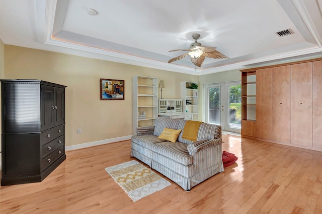 5209 26th Ave W, Bradenton, FL 34209 - living area featuring a tray ceiling, light wood finished floors, ceiling fan, french doors, and baseboards