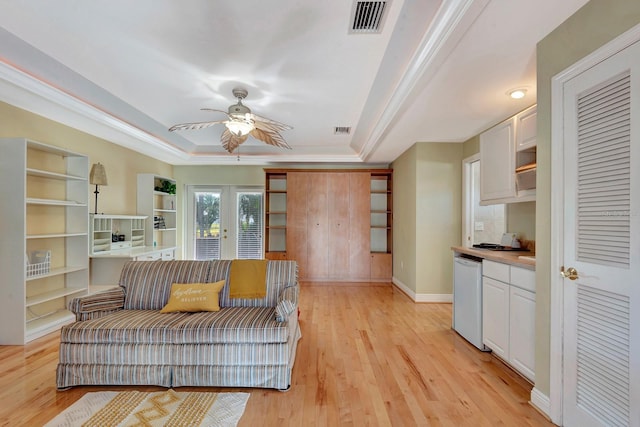 5209 26th Ave W, Bradenton, FL 34209 - sitting room with a raised ceiling, a ceiling fan, light wood finished floors, french doors, and baseboards