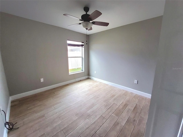 unfurnished room featuring baseboards, ceiling fan, and light wood-type flooring