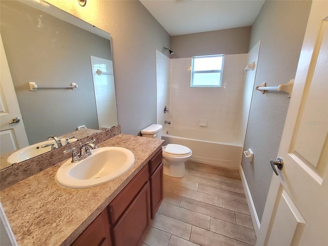 full bath featuring baseboards, toilet, shower / bathing tub combination, and vanity
