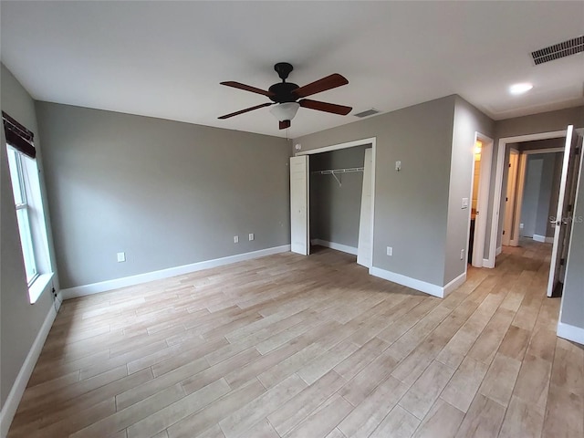 unfurnished bedroom featuring baseboards, visible vents, and light wood-type flooring