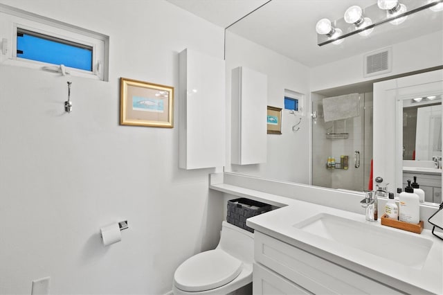 bathroom featuring a stall shower, toilet, and vanity