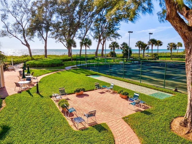 view of home's community featuring a water view and a tennis court