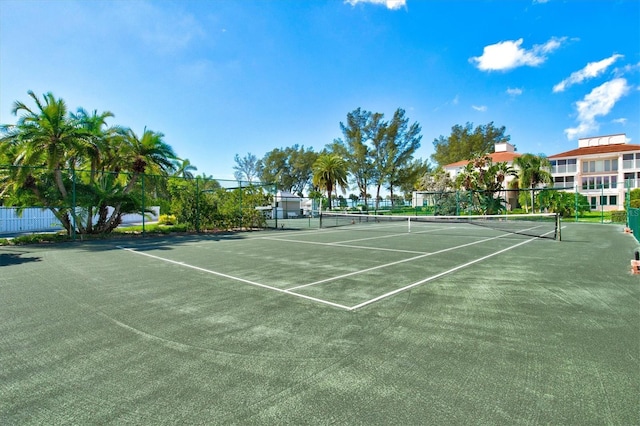view of tennis court featuring fence