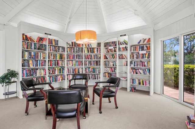 sitting room featuring bookshelves, carpet, wooden ceiling, and built in features