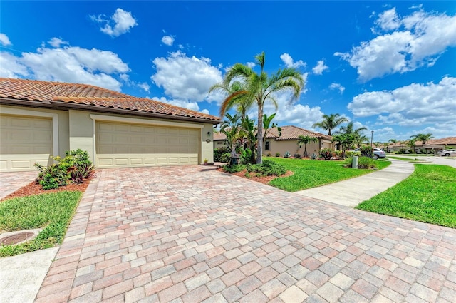 19889 Benissimo Dr, Venice, FL 34293 - view of front facade with stucco siding, a front lawn, a tiled roof, decorative driveway, and a garage