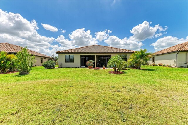 19889 Benissimo Dr, Venice, FL 34293 - back of house with a tile roof, stucco siding, and a yard