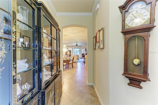 19889 Benissimo Dr, Venice, FL 34293 - hallway featuring baseboards, crown molding, arched walkways, and light tile patterned floors