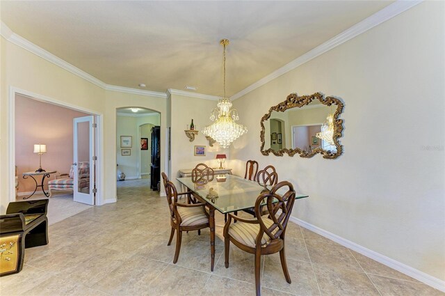 19889 Benissimo Dr, Venice, FL 34293 - dining room with baseboards, crown molding, arched walkways, and a chandelier