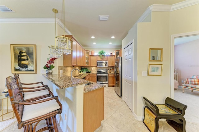 19889 Benissimo Dr, Venice, FL 34293 - kitchen featuring light stone counters, a peninsula, brown cabinets, stainless steel appliances, and visible vents