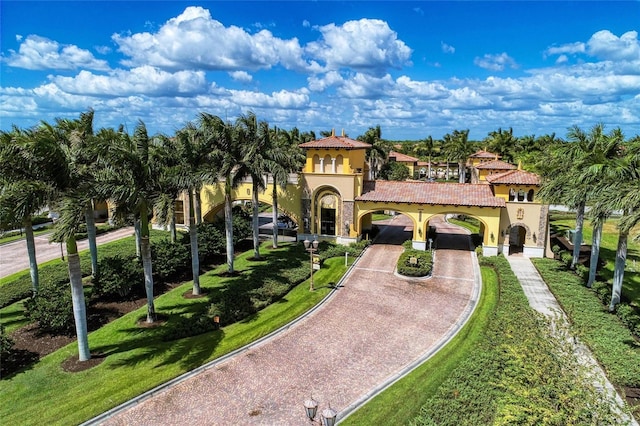 19889 Benissimo Dr, Venice, FL 34293 - mediterranean / spanish house with a tile roof, a front yard, and stucco siding