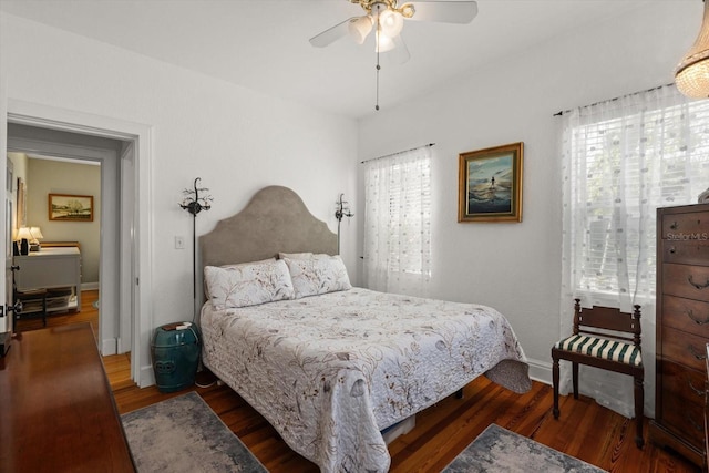 bedroom with baseboards, wood finished floors, and ceiling fan