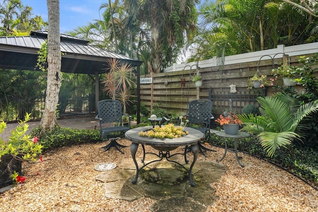 exterior space featuring fence, a gazebo, and a patio area