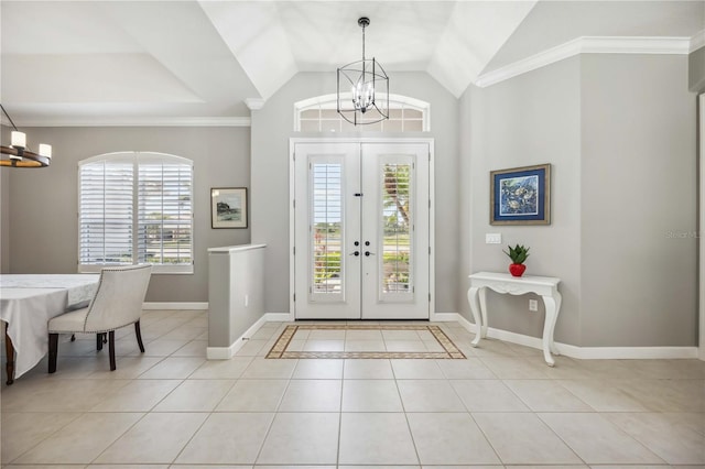 entrance foyer with an inviting chandelier, baseboards, french doors, and light tile patterned flooring