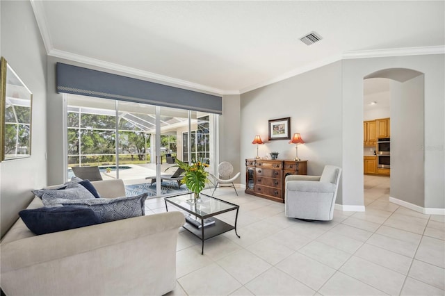 living area with crown molding, arched walkways, a sunroom, and visible vents