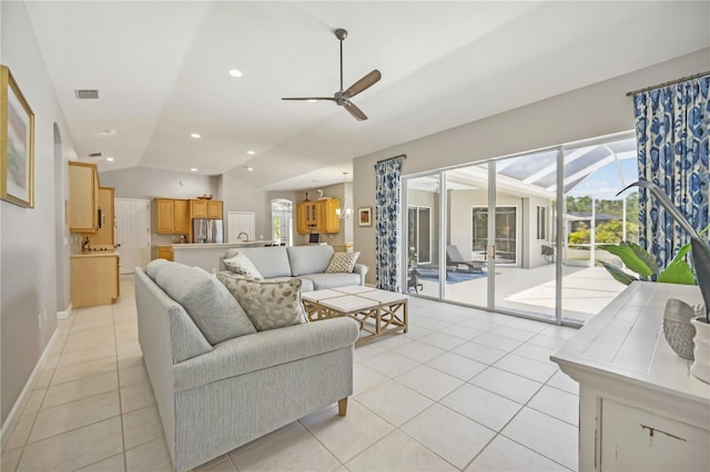 living room featuring light tile patterned floors, ceiling fan, lofted ceiling, and visible vents