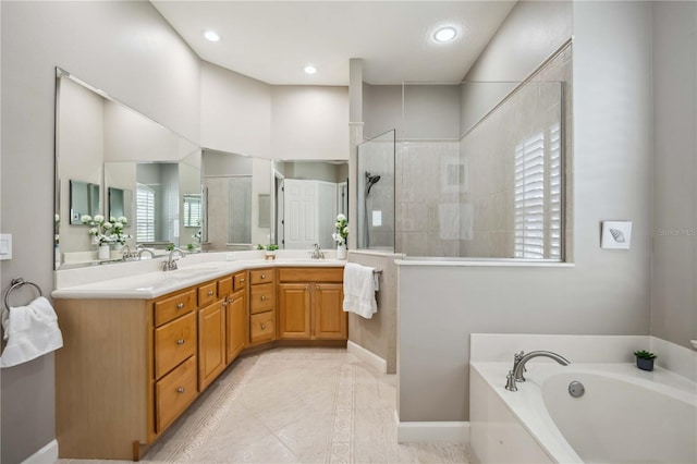 full bathroom featuring a walk in shower, a sink, double vanity, tile patterned floors, and a bath