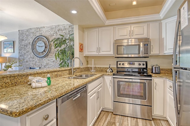 5963 Midnight Pass Rd Unit 355, Sarasota, FL 34242 - kitchen featuring stainless steel appliances, a sink, a tray ceiling, white cabinetry, and recessed lighting