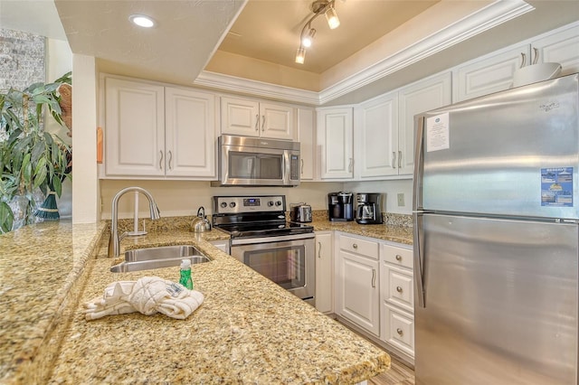 5963 Midnight Pass Rd Unit 355, Sarasota, FL 34242 - kitchen with stainless steel appliances, a sink, a tray ceiling, and white cabinetry