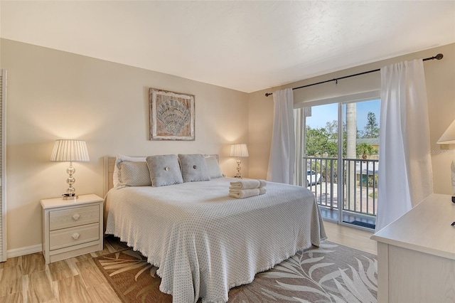 5963 Midnight Pass Rd Unit 355, Sarasota, FL 34242 - bedroom with access to exterior, light wood finished floors, and baseboards
