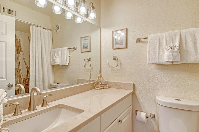 5963 Midnight Pass Rd Unit 355, Sarasota, FL 34242 - bathroom featuring toilet, vanity, a shower with shower curtain, and a textured wall
