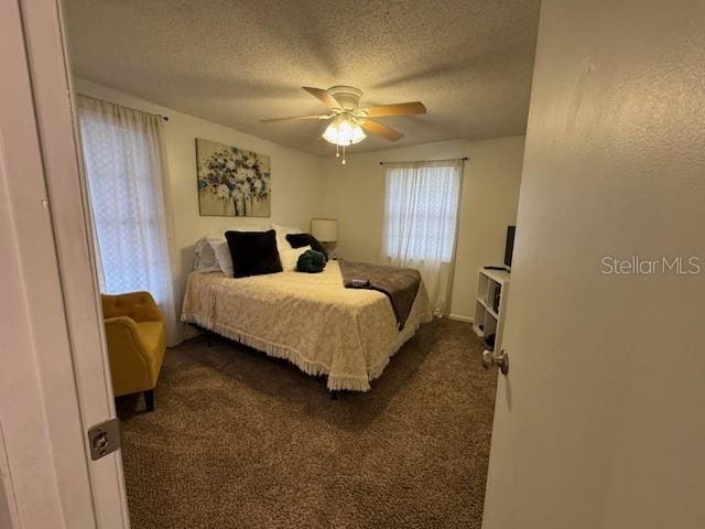 831 Bacon Ave, Sarasota, FL 34232 - bedroom with a ceiling fan, dark colored carpet, and a textured ceiling